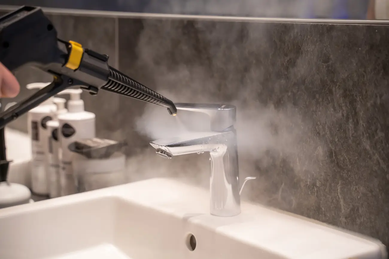 Tap being cleaned chemical-free with micro dry steam